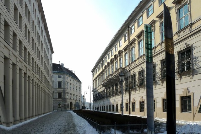 Die Bruno Kreisky-Gasse, links das Innenministerium, rechts das Gebäude des Bundeskanzleramts. Über die Plastik rechts im Bildvordergrund habe ich bis jetzt vergeblich nach Informationen gesucht (bin für Hinweise dankbar!), mir sieht es nach einen Federstiel und einem verrutschten Münzenstapel aus; hoffentlich ist das kein schlechtes Omen?!