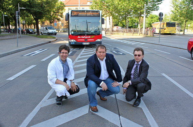 Apotheker Dominik Kaiser, ÖVP Obmann Wolfgang Kieslich und Bezirksrat Leopold Prochazka beweisen: Der Gelenksbus des 73A muss über die neue Sperrfläche fahren.