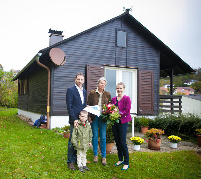 Geschäftsführer Bernhard Mittermayr mit Gattin Claudia und Sohn Markus vor dem ältesten m-haus von Maria Wimmer (Mitte).