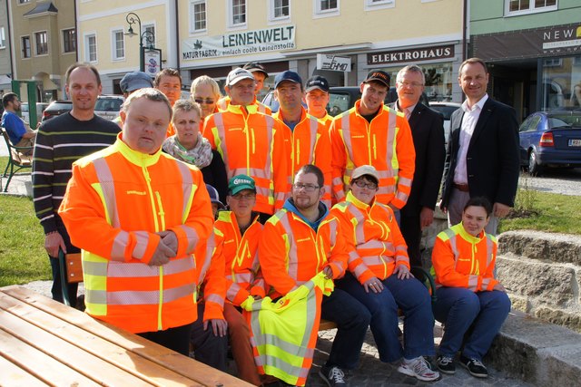 Sparkassen Filialleiter Josef Kobler und Bürgermeister Dominik Reisinger (hinten r) überreichen die neuen Arbeitsjacken an das Oase Mitarbeiter mit Leiter Walter Gierlinger (hinten l).