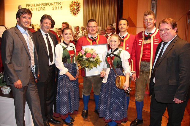 Der geehrte Obmann Hannes Mösl (mi.), flankiert von Marketenderinnen und prominenten Gratulanten. | Foto: Trojer