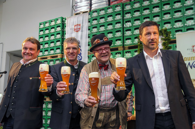 Das Weißbier wird den zahlreichen Pressefotografen präsentiert.