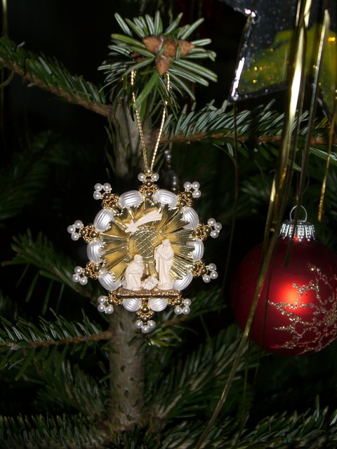 Die Heilige Familie aus Zirbenholz als Anhänger auf underem Christbaum.