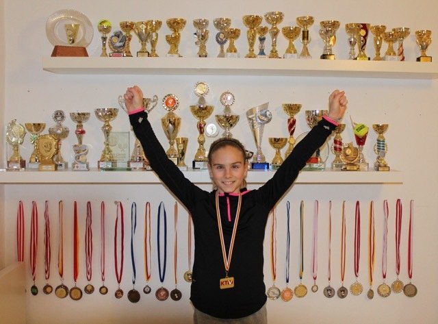 Tennisspielerin Nina Plihal mit ihren zahlreichen Medaillen und Pokalen