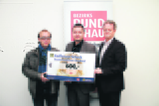 Redaktionsleiter Rainer Auer nimmt den Scheck von Mario Hermüller und Jürgen Höckner entgegen.