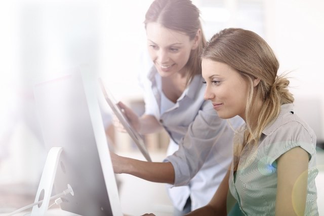 Young women in office working together on desktop