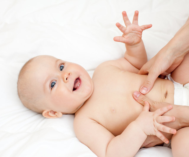 Mother massaging her child, shallow focus