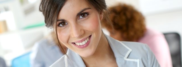 Cheerful young businesswoman in work meeting