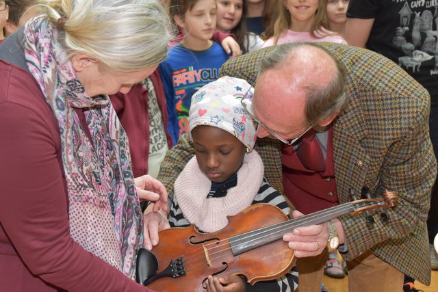 Die siebenjährige Divine Biira freut sich über ihr neues Musikinstrument.