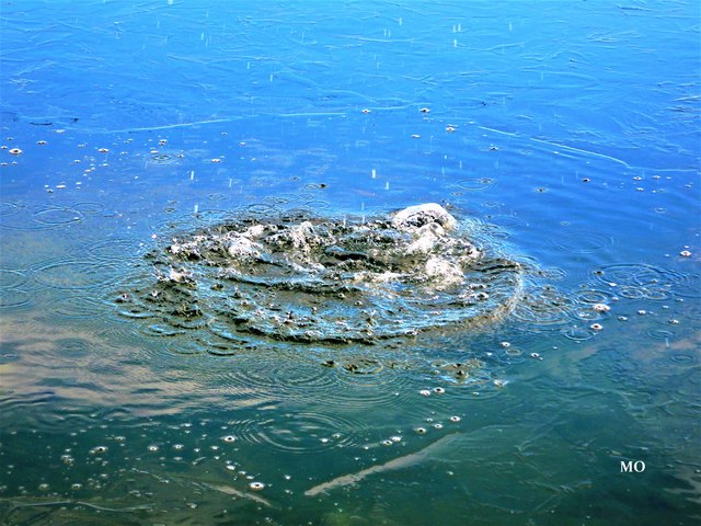Der Stein landet im Schwarzlsee und einige Tropfen fallen schon auf die Wasseroberfläche.