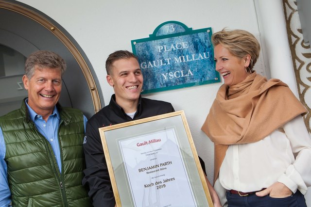 Benjamin Parth (Mitte) wurde von den Herausgebern des Gault&Millau Österreich, Martina und Karl Hohenlohe, zum "Koch des Jahres 2019" gekürt. Gag: Kurzerhand benannte Parth den Vorplatz des Hotel YSCLA in Ischgl aus gegebenem Anlass in "Place Gault Millau" um. | Foto: ProMedia