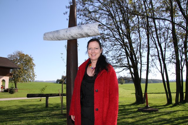 Künstlerin Christiane Pott-Schlager vor dem Friedenskreuz.