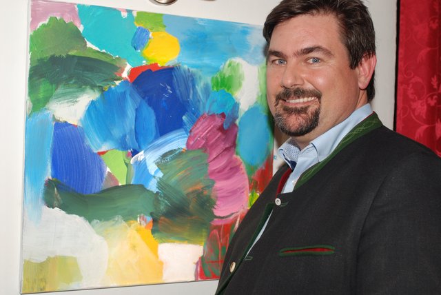 Bürgermeister Stefan Steinbichler betrachtet ein Bild von Christiane Wratschko.