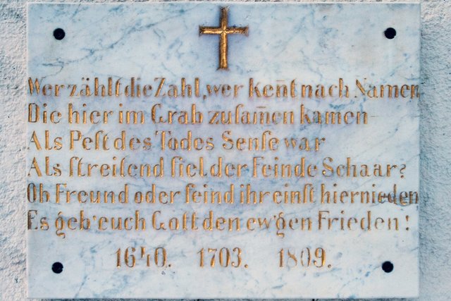 Bild 79: Eine Gedenktafel an der Südfassade der Kirche (links vom Eingang) erinnert  an den Pestfriedhof, welcher sich südlich der Kirche befand.  

 | Foto: © by Ing. Günter Kramarcsik