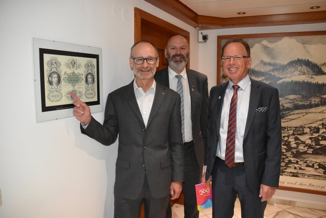Generaldirektor Christoph Paulweber zeigt, passend zum Jubiläumsjahr auf ein Fünf-Gulden-Muster-Poster; Filialleiter Franz Kröll (Mitte) und Alois Stiegler, Leiter des regionalen Beratungszentrums für Firmenkunden.