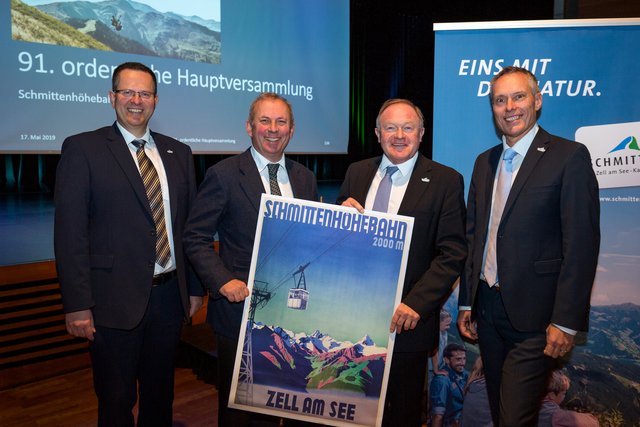 Prokurist Ernst Eder, Vorstands-Vorsitzender Dr. Hans Peter Schützinger, Schmitten-Vorstand Dr. Erich Egger sowie Prokurist Ing. Hannes Mayer präsentieren das Gastgeschenk, ein historisches Plakat.