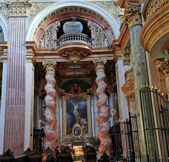 Geschwungene Marmorsäulen bei einem Seitenaltar.