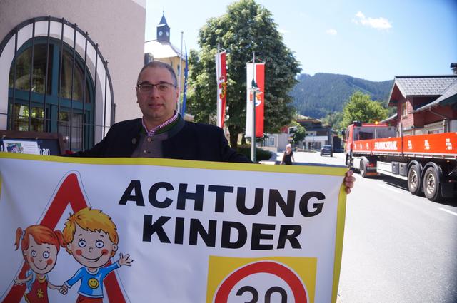 Mit selbstgemachten Schildern will Martin Promok auf die Sicherheit der Kinder aufmerksam machen. 