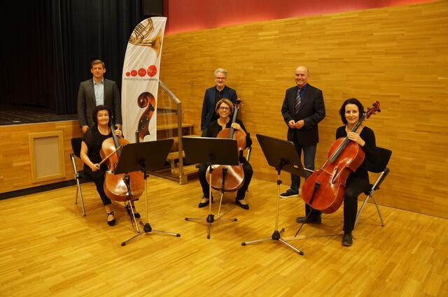 Bei der Präsentation: Philip Hiden, Helmut Turner-Traxler und Heli Pekler mit dem Cello-Ensemble des Kapfenberger Orchesters.