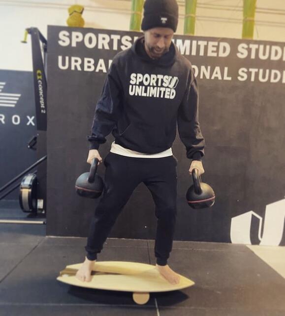 Oliver Spritzendorfer mit Gewichten am  Balance Board.  | Foto: privat