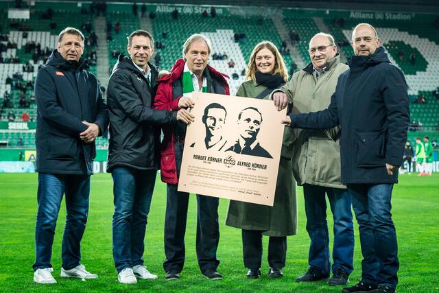 Vor dem letzten Bundesligaspiel wurde die Ehrentafel im Beisein von Alfred und Robert Körner Junior sowie Fredis Enkelin Simone von Martin Bruckner (r.), Christoph Peschek (2.v.l.) und Zoran Barisic (l.) präsentiert.  | Foto: SK Rapid | Red Ring Shots