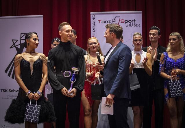 Wiener Landesmeister der Lateintänze: Tim Grabenwöger im Interview mit Jakob Glanzner.
Eingebettet in das 90-Jahre-Jubiläum des TSK Schwarz-Weiss Wien, fand in den Sophiensälen die Wiener Landesmeisterschaft der Lateintänze statt. Als Gäste wurden unter anderem die Promidamen aus dem ORF-Format Dancing Stars begrüßt.
Mit Kernölamazone Caroline Athanasiadis und Gudrun Nikodem-Eichenhardt