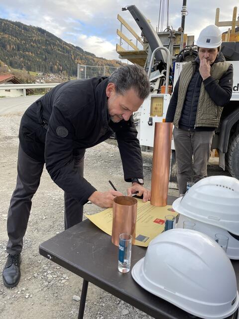Auch TIGEWOSI-Prokurist Edgar Gmeiner unterschreibt die Urkunde für die Zeitkapsel.