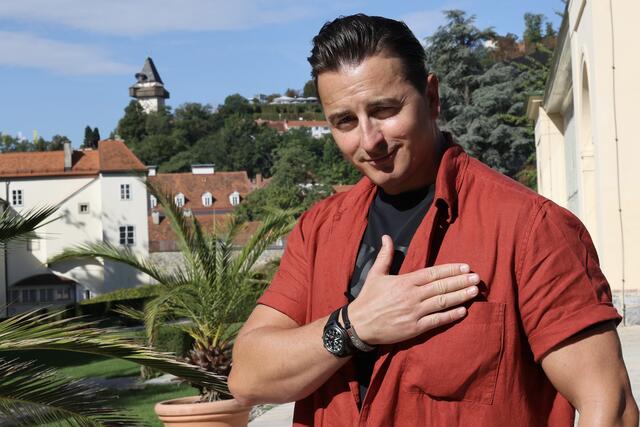 Hand aufs Herz: Gabalier mit dem Grazer Uhrturm im Hintergrund. | Foto: STG