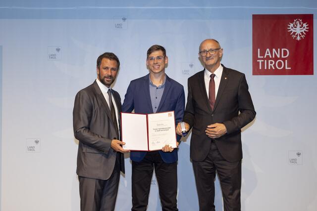 LH Anton Mattle (re.) und Sportlandesrat Georg Dornauer (li.) überreichten Daniel Stütz die Tiroler Sportehrennadel in Gold mit Brillant.  | Foto: © Land Tirol/Webhofer
