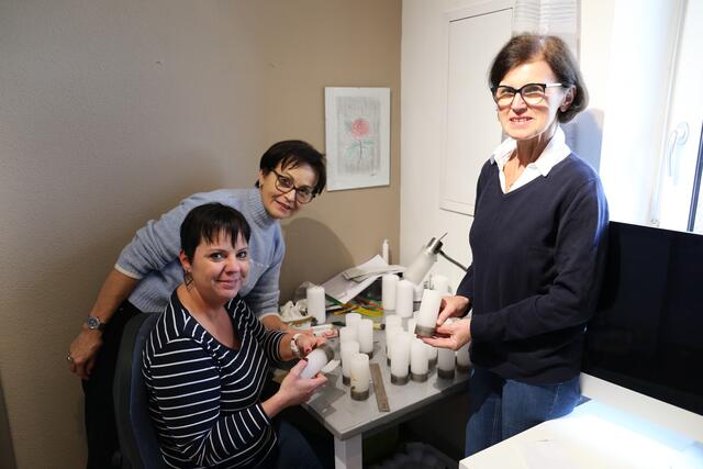 Helene Feichtinger, Obfrau Gabi Klinglmayr und Hermine Angerbauer bei der Dekoration der Heilig-Nacht-Kerze