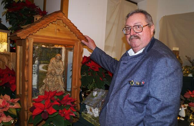 Obmann Günther Hopfgartner vor der prächtigen Laternenkrippe von Gundi Rettenbacher.