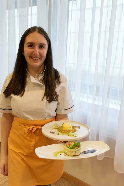 Maria Grubmüller mit Ziegenfrischkäse-Törtchen mit Avocado-Mango-Salat (Teller oben) und marinierten Mozzarella im Zucchinimantel (Teller unten). | Foto: Julia Liedl