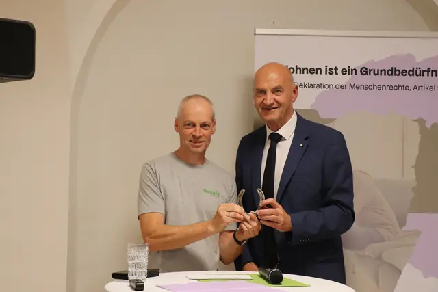 Landesrat Christian Dörfel (r.) überreichte Mosaik-Leiter Stefan Hindinger ein Hufeisen als Glücksbringer für das Tageszentrum.