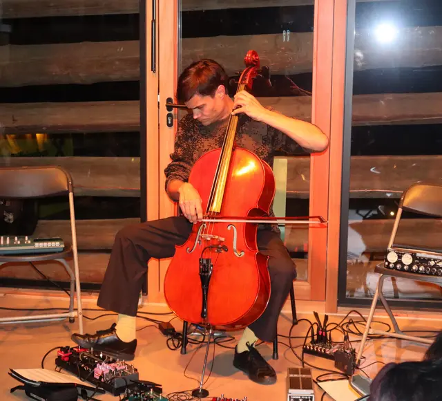 Lukas Lauermann konzentriert beim Streichen des Cellos und der Bedienung eines Effektpedals. | Foto: Tatschl