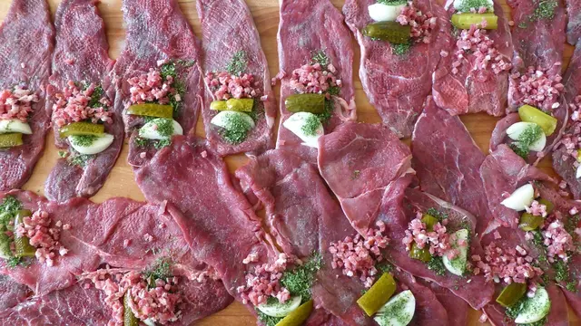 Die Schnitzel eng aufrollen und sie sicher mit Zahnstochern oder Küchengarn fixieren, damit die Rouladen beim Braten nicht auseinanderfallen.