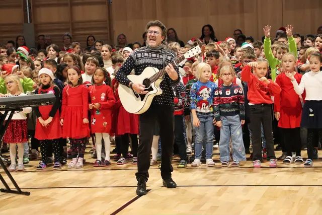 Sänger und Komponist Peter Karpf singt mit Schülern der VS Kalsdorf „Weihnachten daham“. | Foto: Edith Ertl