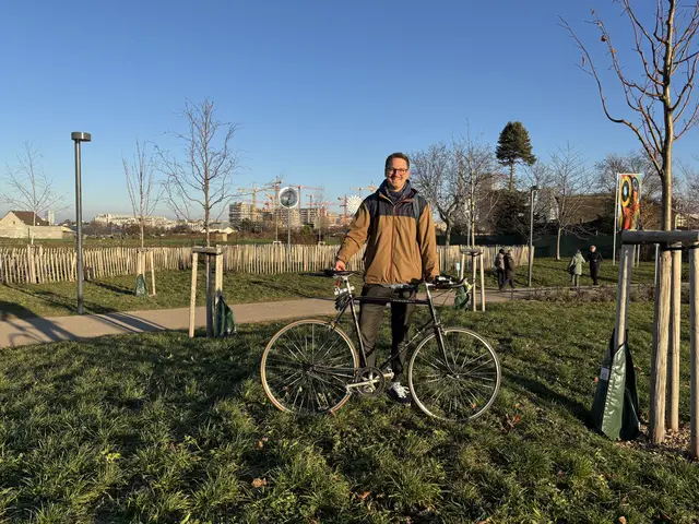 Die Baugruppe "Treibhaus Donaufeld" hat ein Crowdfunding gestartet, um zwei Familien im Gebäude wohnen zu lassen, das hinter Dennis Walden aktuell errichtet wird: Neun Stockwerke, 50 Wohneinheiten und Platz für 80 Erwachsene mit 35 Kindern. | Foto: Mathias Kautzky/MeinBezirk