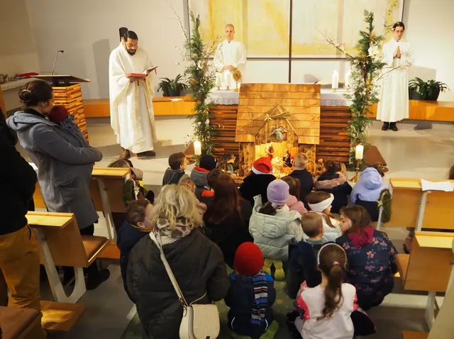 Kurat Felician mit den Kindern vor der Krippe