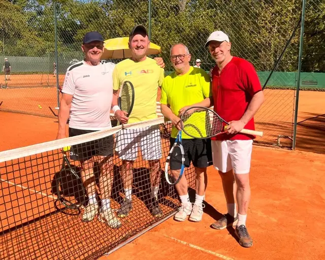 Vier Männer am Tennisnetz