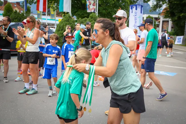 Kind bekommt Medaille überrreicht