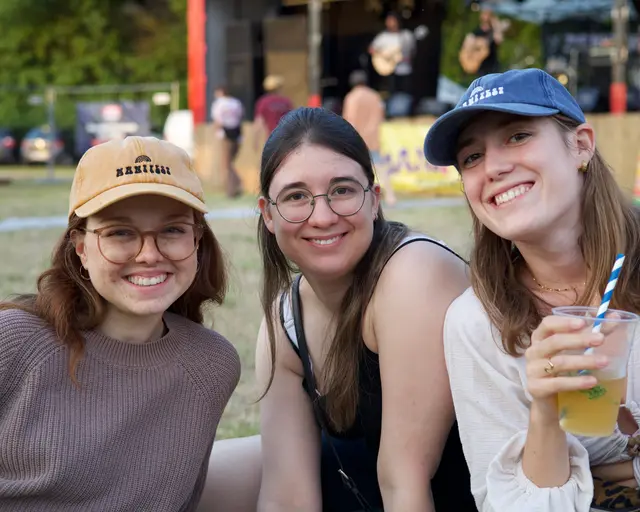 Drei Frauen mit Kappen und Cocktails