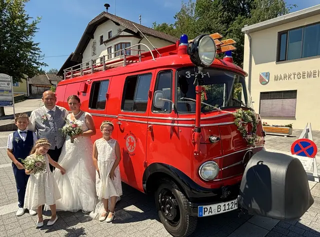 Feuerwehrkameradschaft über die Grenzen hinweg: Ein Feuerwehr Oldtimerfahrzeug von der Feuerwehr Passau – Löschzug Innstadt – holte das Brautpaar zu Hause ab und brachte sie zur Hochzeit. Das glückliche Brautpaar Günter Pichler und Jasmin Jaksic mit ihren Kindern Sebastian, Magdalena und Johanna. | Foto: Gruber