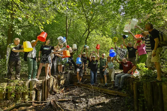 Mit einer symbolischen Kübelkette machten Aktivistinnen und Aktivisten am Staudigl-Damm auf die Trockenheit in der Unteren Lobau aufmerksam.
 | Foto: z.V.g.