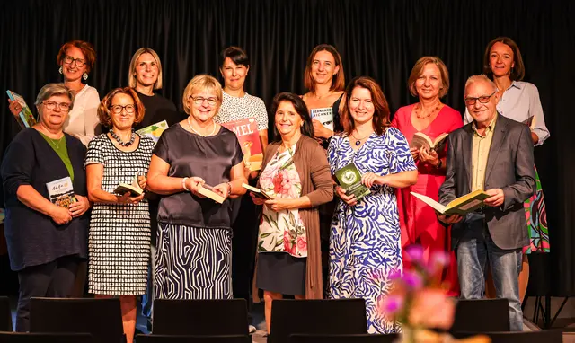 Eine Gruppe von Männern und Frauen mit Büchern in der Hand