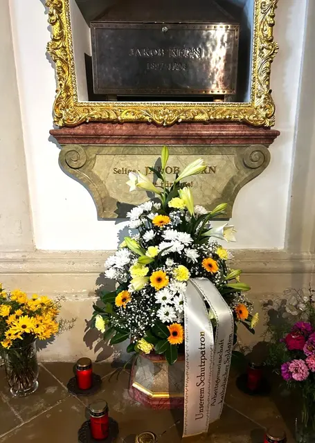 Der Blumenschmuck beim Schrein des Seligen 
Jakob Kern mit der Inschrift auf den Bändern: "Arbeitsgemeinschaft Katholischer Soldaten"